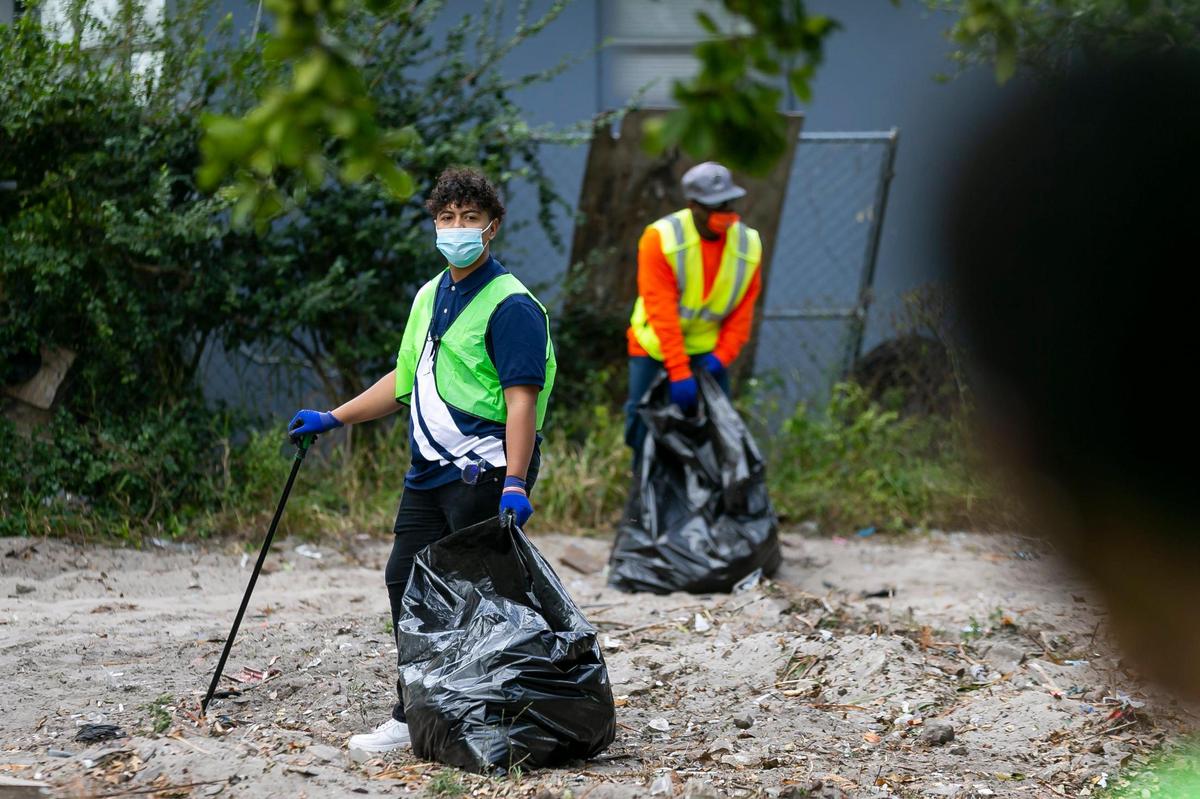 Volunteer Henry Aguilera, 18, participates in a Community Cleanup at Magnolia Park in Opa-locka, Florida on Saturday, January 30, 2021. Miami-Dade County Commission Vice Chairman Oliver G. Gilbert, III, and Opa-locka Vice Mayor Veronica Williams hosted the event.