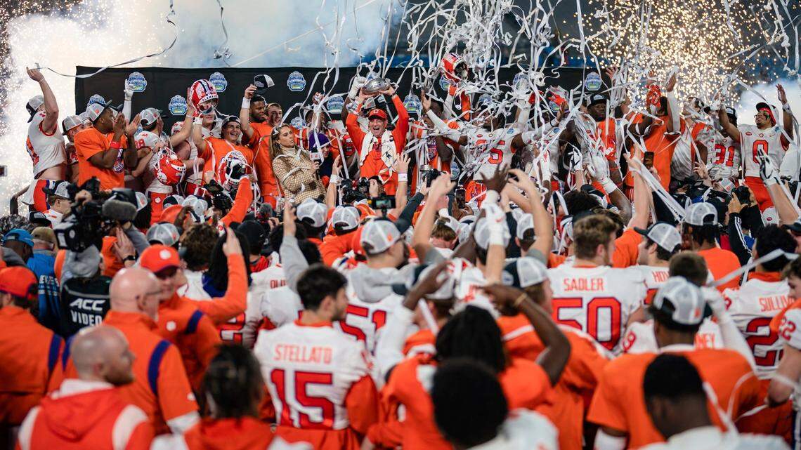 Clemson coach Dabo Swinney holds up the trophy after Clemson defeated North Carolina in the Atlantic Coast Conference championship NCAA college football game Saturday, Dec. 3, 2022, in Charlotte, N.C. (AP Photo/Jacob Kupferman)
