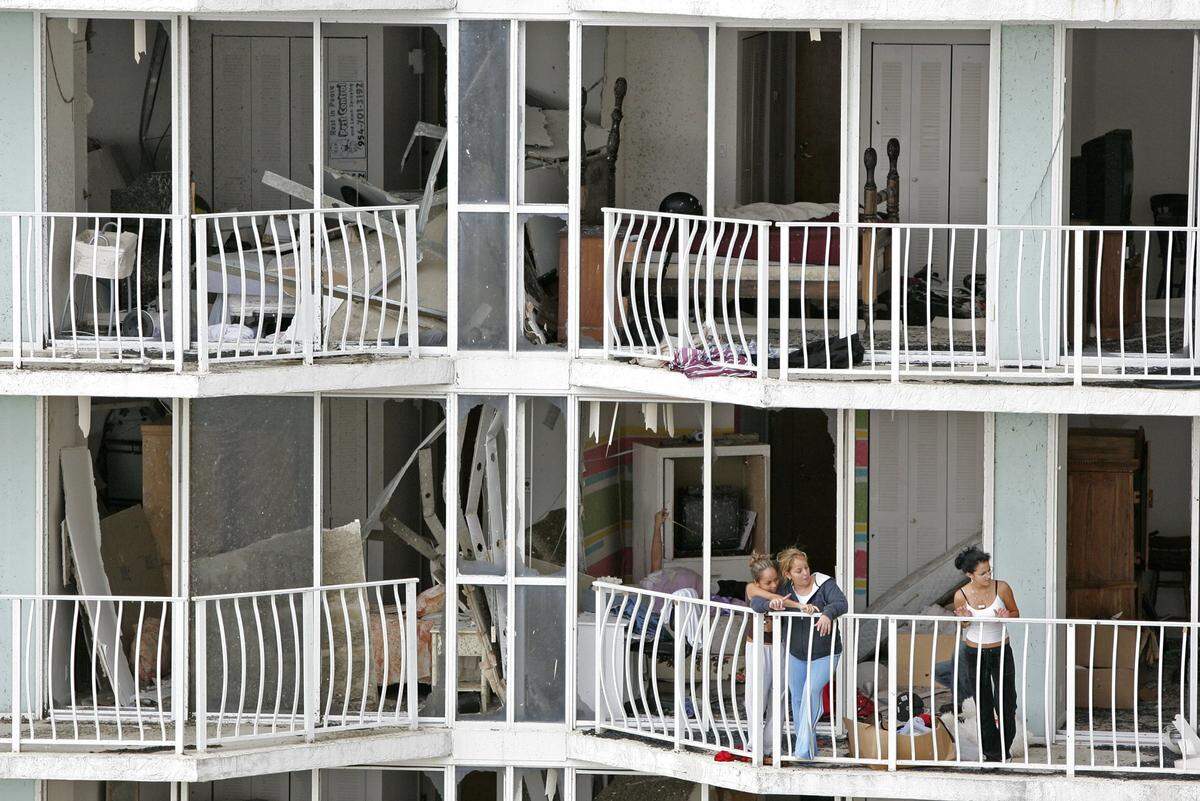 Residents of North Bay Village’s Grand View Palace survey the damage to their units at 7601 E. Treasure Dr.