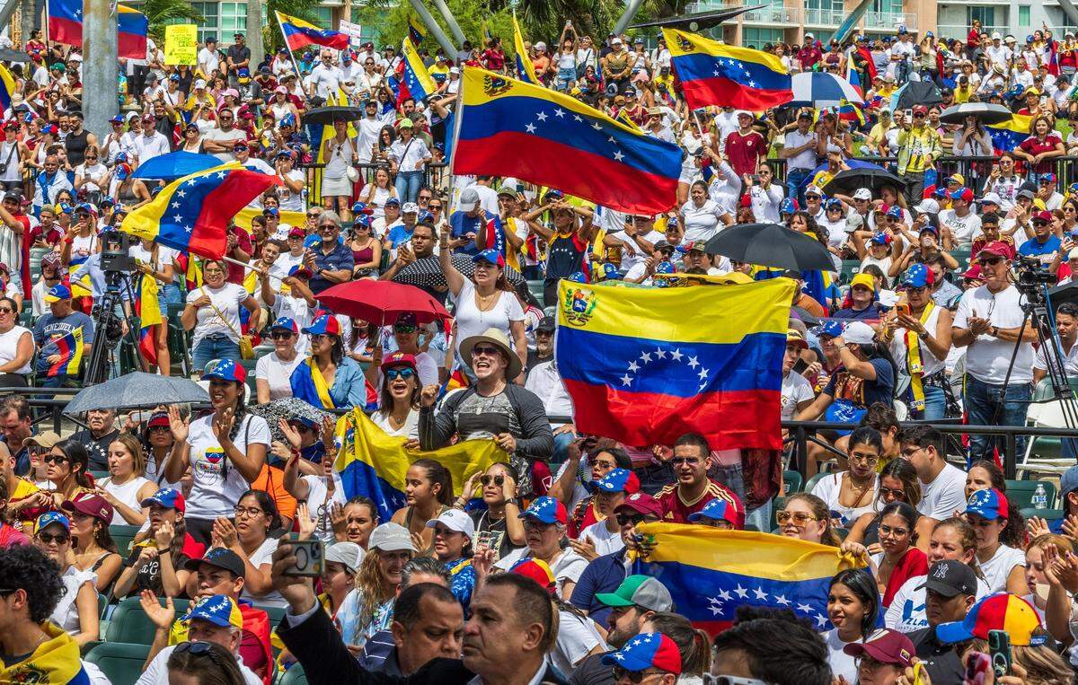 Venezuelans living in Miami wave their national flag and chant ‘Freedom, Freedom, Freedom’ in Bayfront Park.