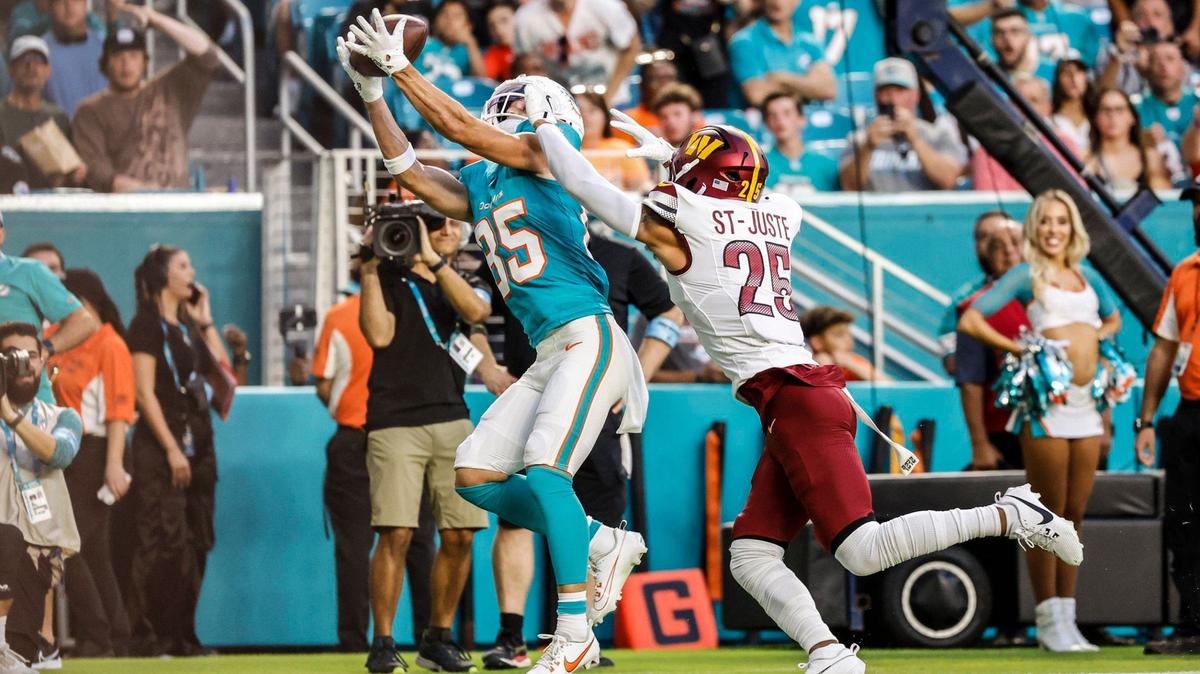 Miami Dolphins wide receiver River Cracraft (85) catches a pass for a touchdown in the first quarter as Washington Commanders cornerback Benjamin St-Juste (25) defends in the first quarter at Hard Rock Stadium in Miami Gardens, Florida on Saturday, August 17, 2024.
