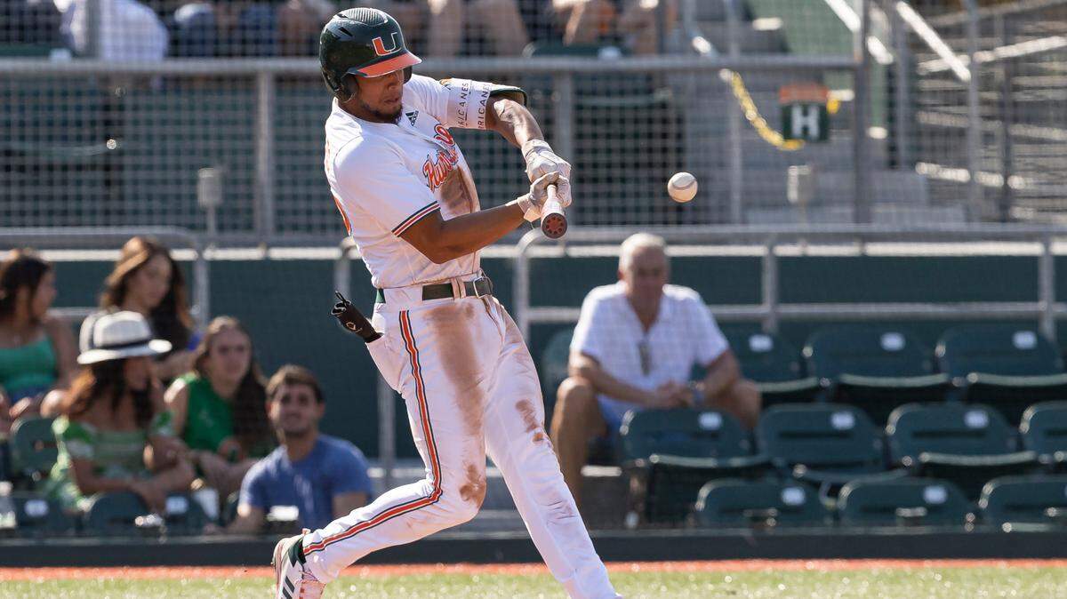 Miami Hurricanes infielder Yohandy Morales (35) doubles to left field against Dartmouth during the sixth inning of a NCAA baseball game at Alex Rodriguez Park at Mark Light Field on Sunday, Feb. 26, 2023, in Coral Gables, Fla.