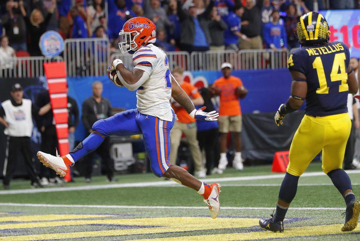 Florida running back Lamical Perine (22) runs into the end zone for a touchdown against Michigan during the first half of the Peach Bowl NCAA college football game, Saturday, Dec. 29, 2018, in Atlanta. (AP Photo/John Bazemore)