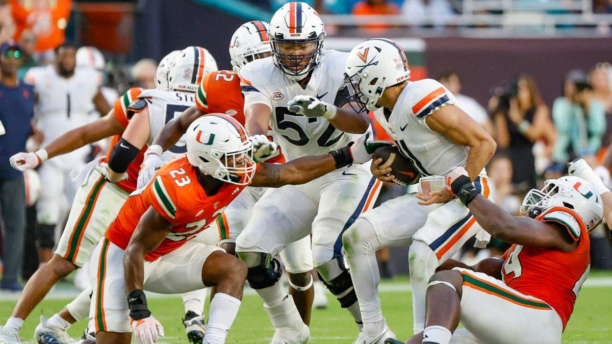 Miami Hurricanes defensive lineman Rueben Bain Jr. (44) sacks Virginia Cavaliers quarterback Tony Muskett (11) in the second half at Hard Rock Stadium in Miami Gardens on Saturday, October 28, 2023.