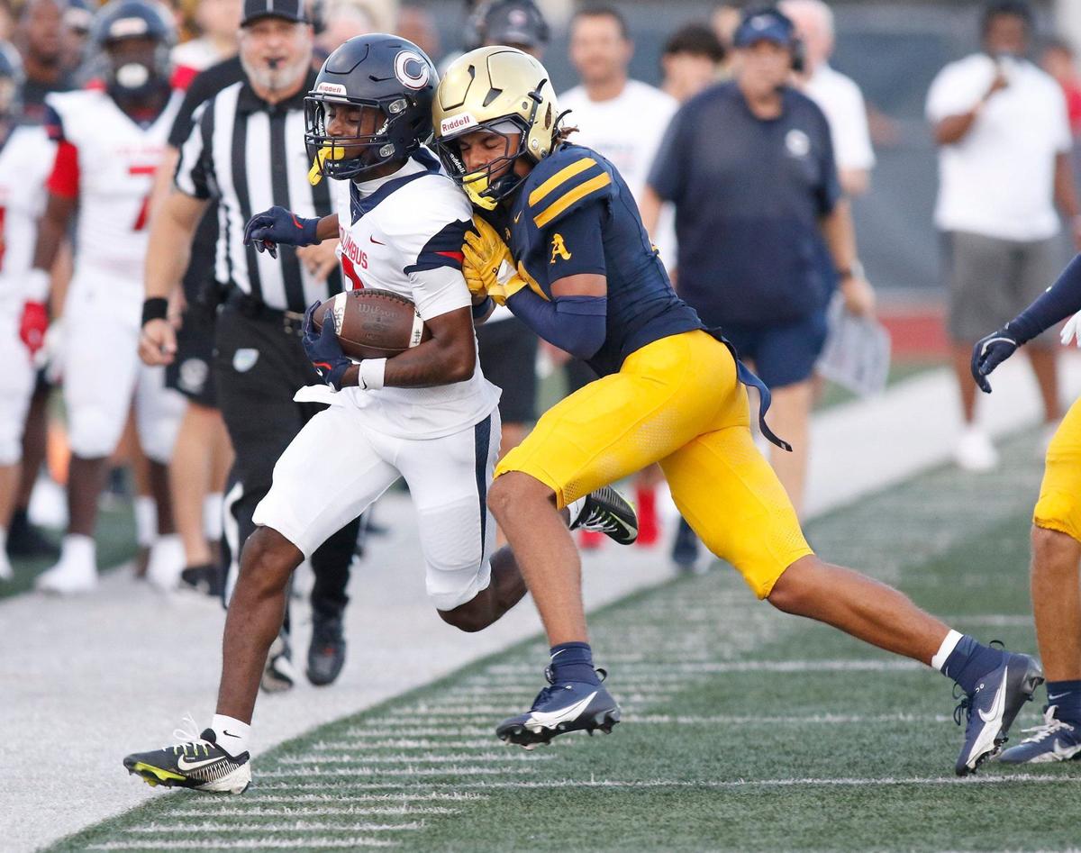 Columbus Explorers wide reciver Khamari Marceus is pushed out of the field by St. Thomas Aquinas Raiders defender during football game on Friday, September 6, 2024 at St. Thomas Aquinas HS in Fort Lauderdale. Andrew Uloza / for Miami Herald