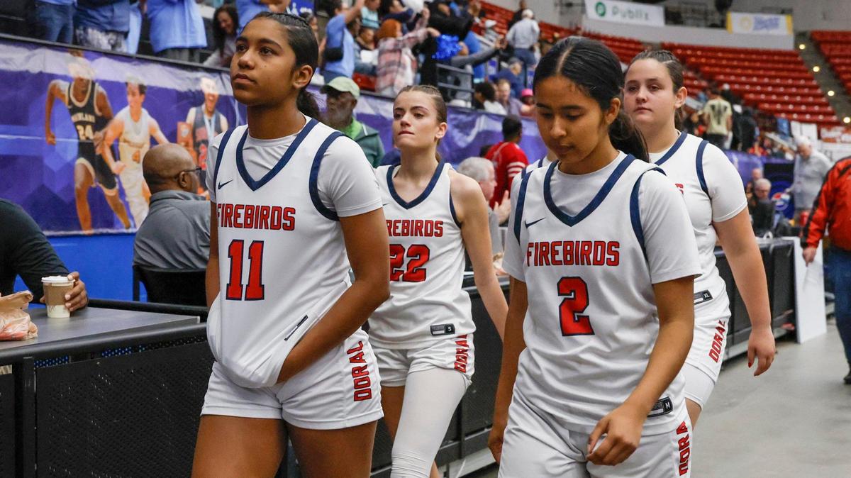 Doral Academy’s Angelina Deleon (11) and Madison Londono (2), Ashley Martinez (22) and teammates leave the court after being defeated by Dr. Phillips High School in the semi-final for the FHSAA Class 7A Girls High School Basketball State Championship at the RP Funding Center in Lakeland, Florida on Friday, March 7, 2025.