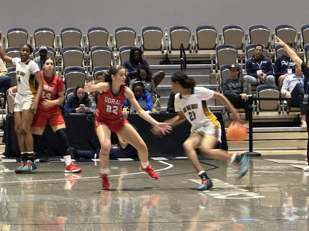 Doral Academy guard Ashley Martinez (left) guards Winter Haven’s Faith Thompson (right) during Saturday’s Class 7A girls’ basketball championship game at UNF Arena in Jacksonville, Fla.