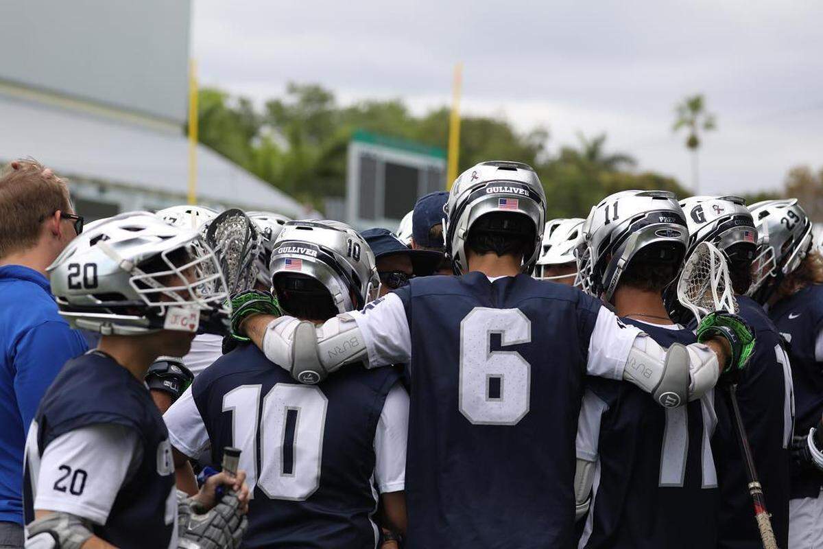 Gulliver Prep’s Marcelo Arteaga (6) huddles with his teammates.