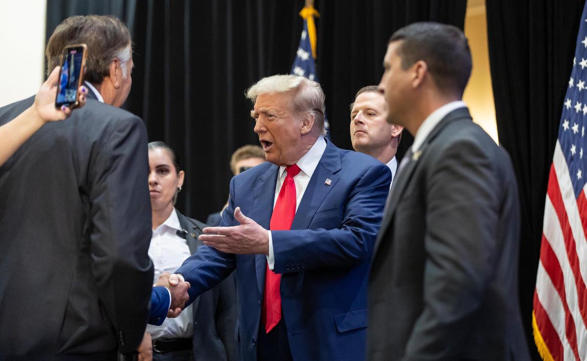 Republican presidential candidate and former President Donald Trump greets supporters as he arrives to a roundtable discussion with local Latino leaders at Trump National Doral Miami on Tuesday, Oct. 22, 2024, in Doral, Fla.