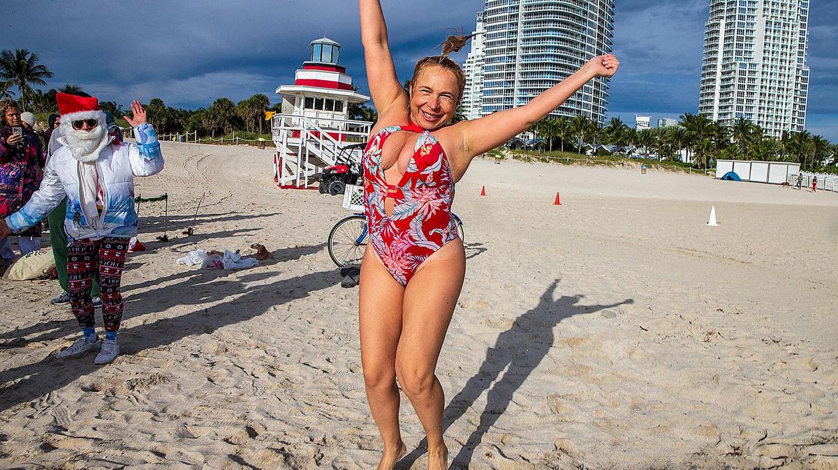 As Miami hit a low of 48 around 6 a.m. Saturday, Dec. 24, 2022, Marina Mak, of South Beach took a swim as she joined a group of friends that celebrated Christmas at South Pointe, Miami Beach, with a joint swim despite the cold temperatures in Florida.