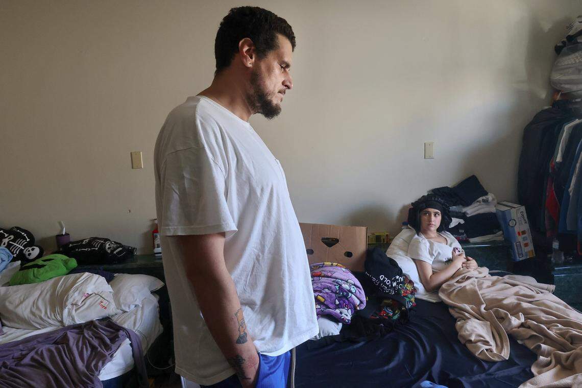 Michael Torres, left, Diana Olivo, Maylynda, right, and her two brothers, not pictured, have been sharing a motel room for the last six months. He does not know how long they'll be able to afford to stay there, and he reflects on the challenges of being unsheltered on Wednesday, February 25, 2026, in Miami-Dade, Florida.