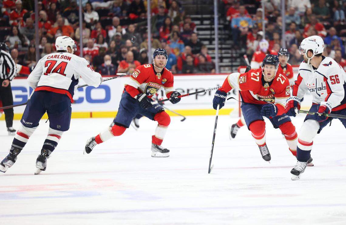 Florida Panthers center Sam Bennett (9) and Florida Panthers center Eetu Luostarinen (27) look up at the puck in the air during the third period of an NHL game at FLA Live Arena in Sunrise, Florida, on Tuesday, Nov. 15, 2022, around Doral.