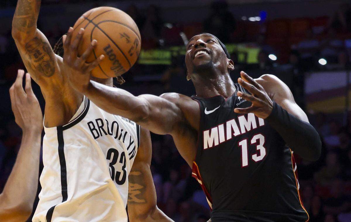 Miami Heat center Bam Adebayo (13) shoots over Brooklyn Nets center Nic Claxton (33) during the first half of a game on Tuesday, March 3, 2026, at the Kaseya Center in downtown Miami, Fla. 