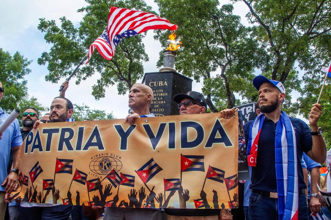 Cuban exiles stop at the Bay of Pigs Monument as they joined a march called by the Kiwanis Club of Little Havana along Southwest Eighth Street to show solidarity and support for the Cuban people asking for freedom and the end of 62 years of an oppressive authoritarian regime on the island. The Miami march was held Friday, July 23, 2021.
