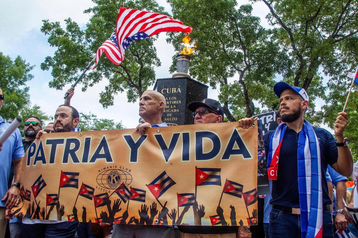 Cuban exiles stop at the Bay of Pigs Monument as they joined a march called by the Kiwanis Club of Little Havana along Southwest Eighth Street to show solidarity and support for the Cuban people asking for freedom and the end of 62 years of an oppressive authoritarian regime on the island. The Miami march was held Friday, July 23, 2021.