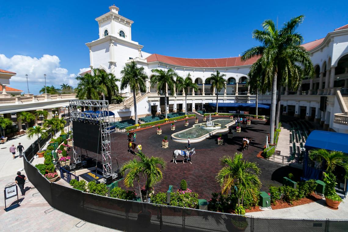 A black fence surrounds the paddock walking ring as horses are seen strutting before a race at Gulfstream Park Racing and Casino in Hallandale Beach, Florida on Friday, March 13, 2020. Organizers have decided to continue racing horses but are preventing fans from attending the event due to fears of possible COVID-19 transmissions.