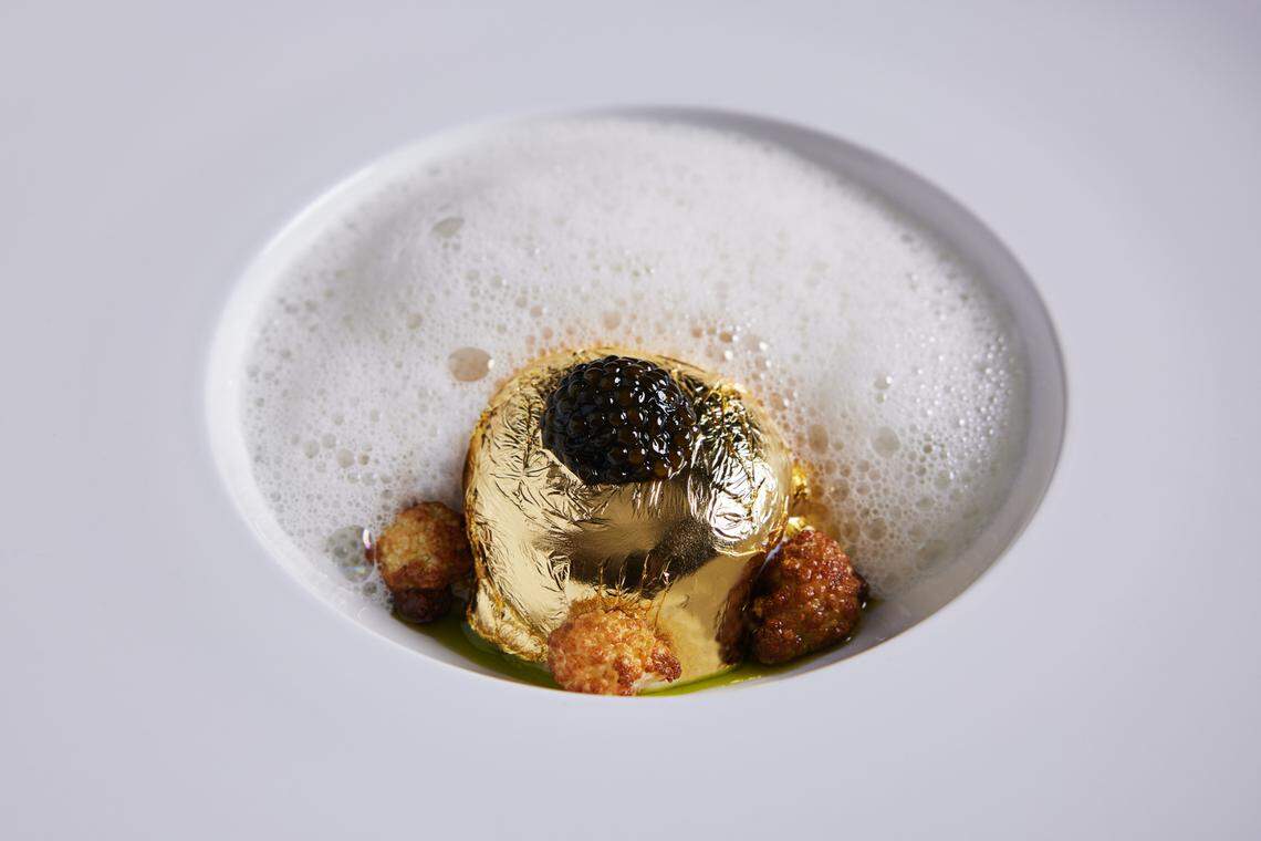 The Golden Egg is topped with caviar, surrounded by foam and accented with cauliflower bites. Swirl it all together and witness the majesty.