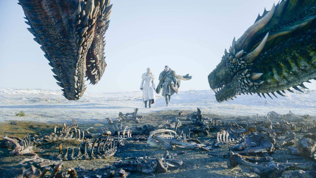 This image released by HBO shows Emilia Clarke, left, and Kit Harington in a scene from the final episode of “Game of Thrones.”