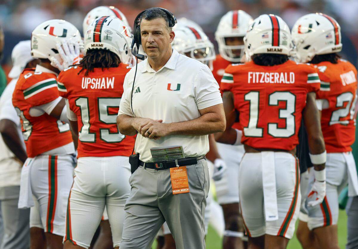 Miami Hurricanes head coach Mario Cristobal on the field during a time out of an NCAA football game against the Syracuse Orange at Hard Rock Stadium in Miami Gardens, Florida on Saturday, November 8, 2025.