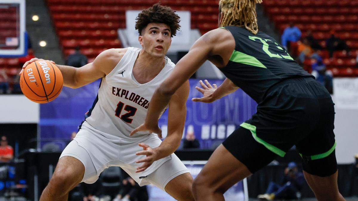 Columbus High School’s Cameron Boozer (12) controls the ball as Windermere’s Terrance Drain (23) defends in the first half of the FHSAA Class 7A Final for Boys High School Basketball State Championship at the RP Funding Center in Lakeland, Florida on Saturday, March 8, 2025.