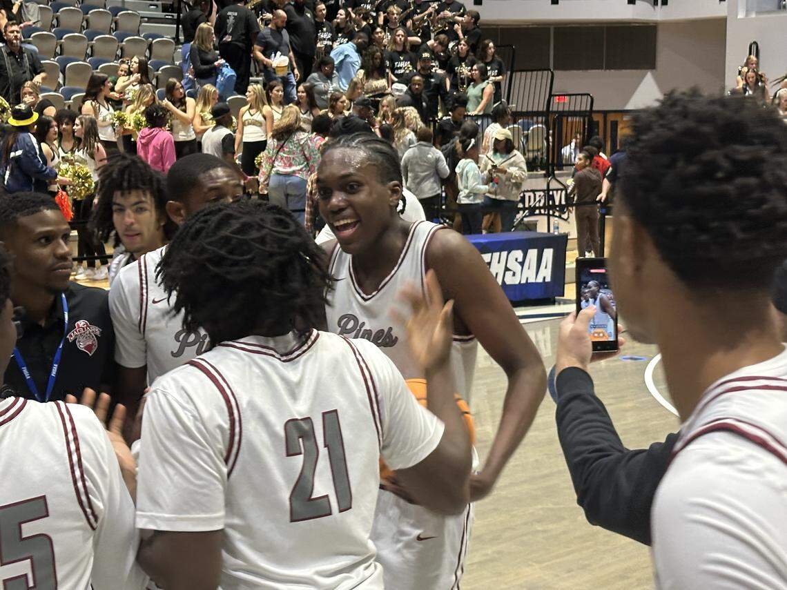 Pembroke Pines Charter forward Robert Guishard celebrates with his teammates after the Jaguars won the Class 5A state boys’ basketball championship on Friday at UNF Arena in Jacksonville, Fla.