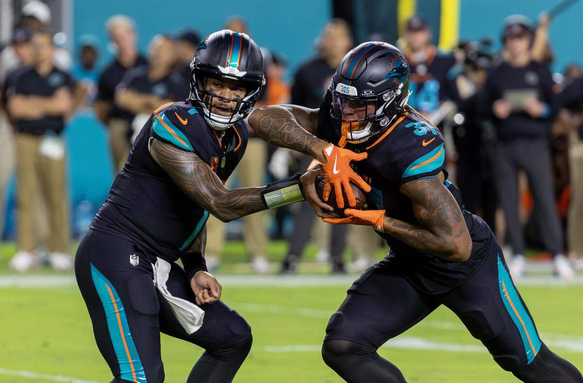 Miami Dolphins quarterback Tua Tagovailoa (1) hands off to running back Ollie Gordon II (31) during the first half of an NFL game against the New York Jets at Hard Rock Stadium on Monday, Sept. 29, 2025, in Miami Gardens, Fla.