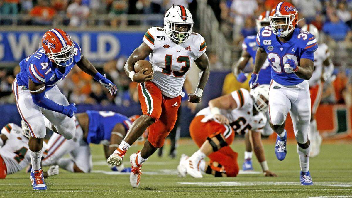Former Miami Hurricanes running back DeeJay Dallas (13) out runs Gator defenders as the University of Miami plays the University of Florida at Camping World Stadium to open the 2019 season. UM again opens the season against UF in 2024.