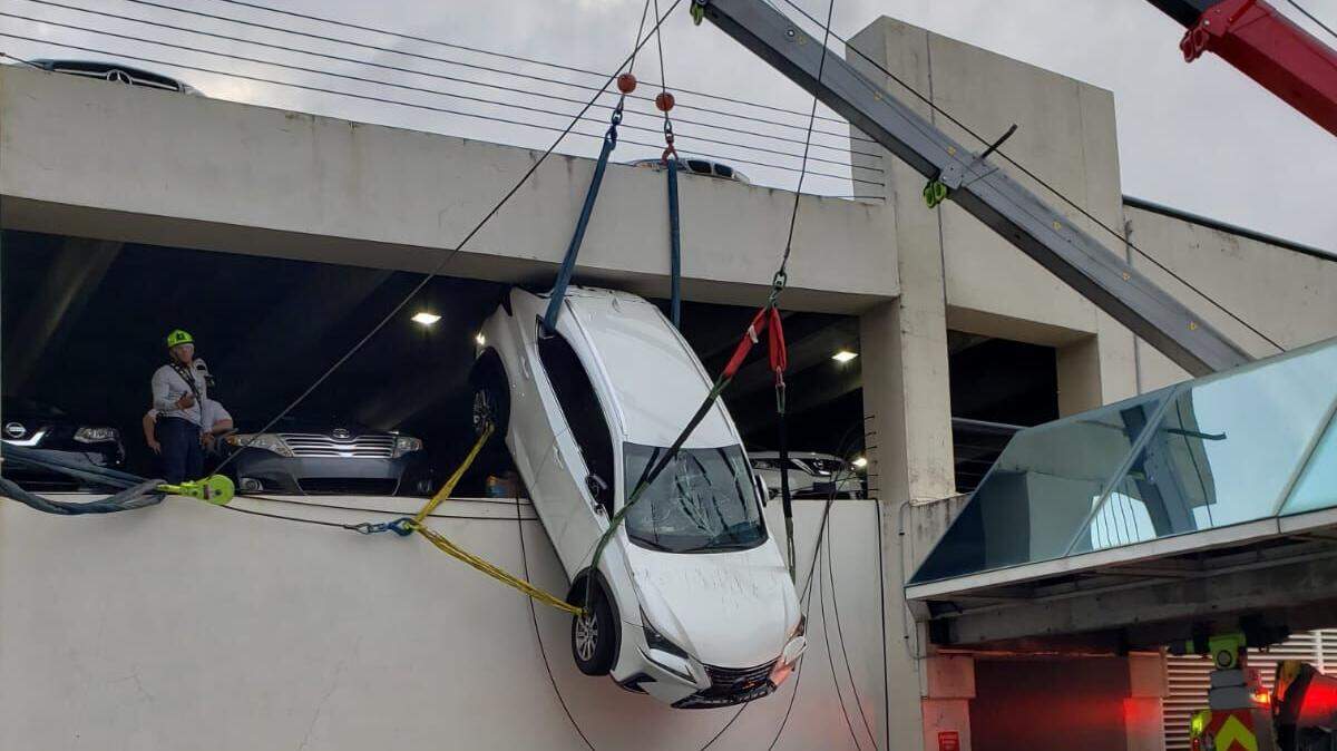 Miami-Dade Fire Rescue crews rescued a driver from an SUV that was left dangling from a Miami Springs parking garage April 4, 2019.