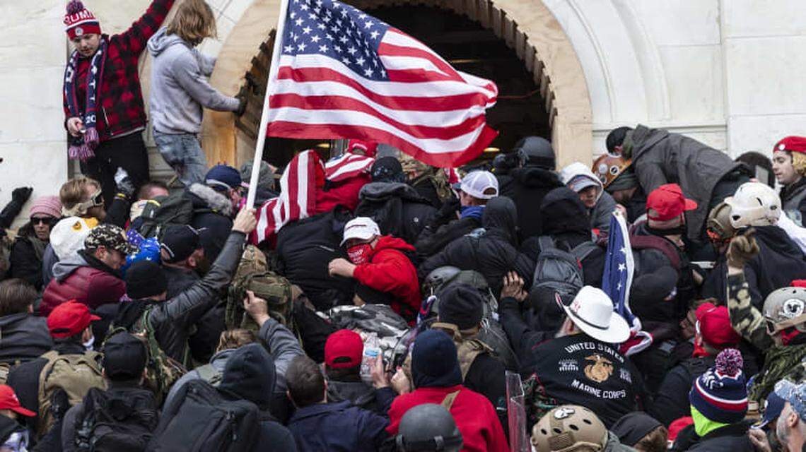 Rioters trying to enter the U.S. Capitol building through the front doors clash with police.