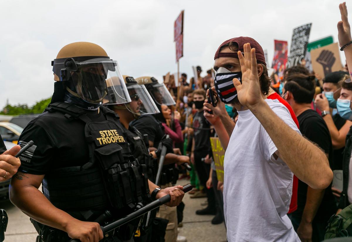 Protesters and Florida Highway Patrol officers meet on one of the ramps of the Julia Tuttle Causeway on Friday, June 5, 2020, during a Justice for George Floyd rally that began in Wynwood.