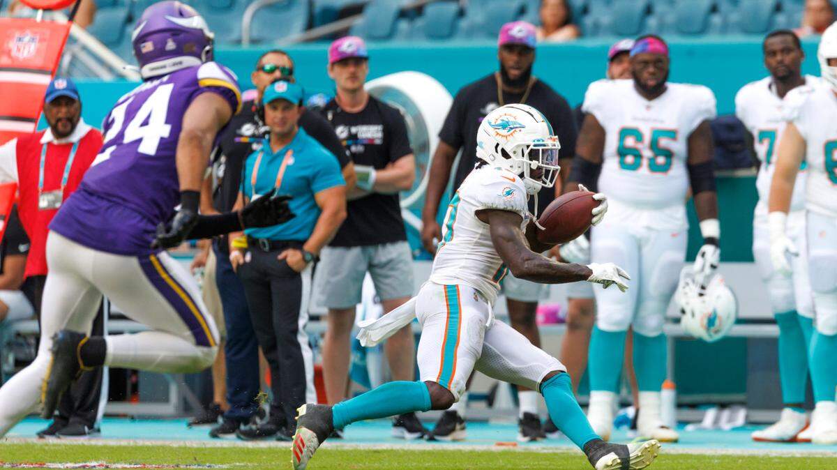 Miami Dolphins wide receiver Tyreek Hill (10) runs with the football against Minnesota Vikings safety Camryn Bynum (24) during fourth quarter of an NFL football game at Hard Rock Stadium on Sunday, October 16, 2022 in Miami Gardens, Florida.