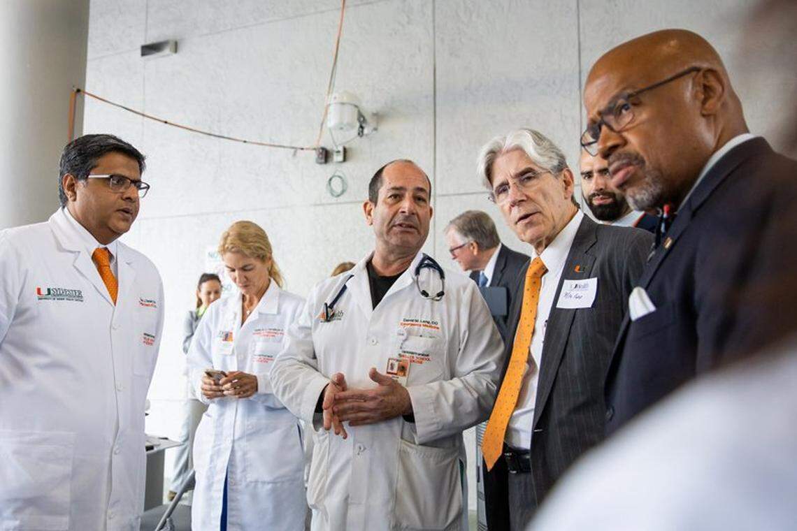 A file photo from July 2020. University of Miami President Julio Frenk, in orange tie, confers with, from left, Drs. Dipen Parekh, Tanira Ferreira, David Lang, UHealth Emergency Manager Vincent Torres, back right, and UM Miller School of Medicine Dean Henri Ford, right, on the medical campus as they discuss demand surge during the coronavirus pandemic.