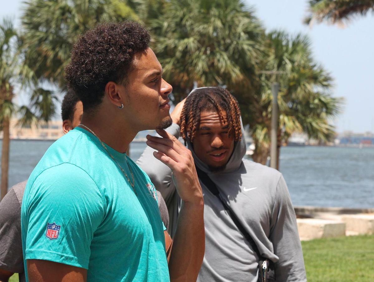Cameron Goode, signed member of the Miami Dolphins rookie class, left, participates in a historic walking tour of Downtown Miami with local community groups on Wednesday, June 15, 2022, beginning with tour leaders at the History Miami Museum. Goode is one of four players actually signed to the roster for this coming season.