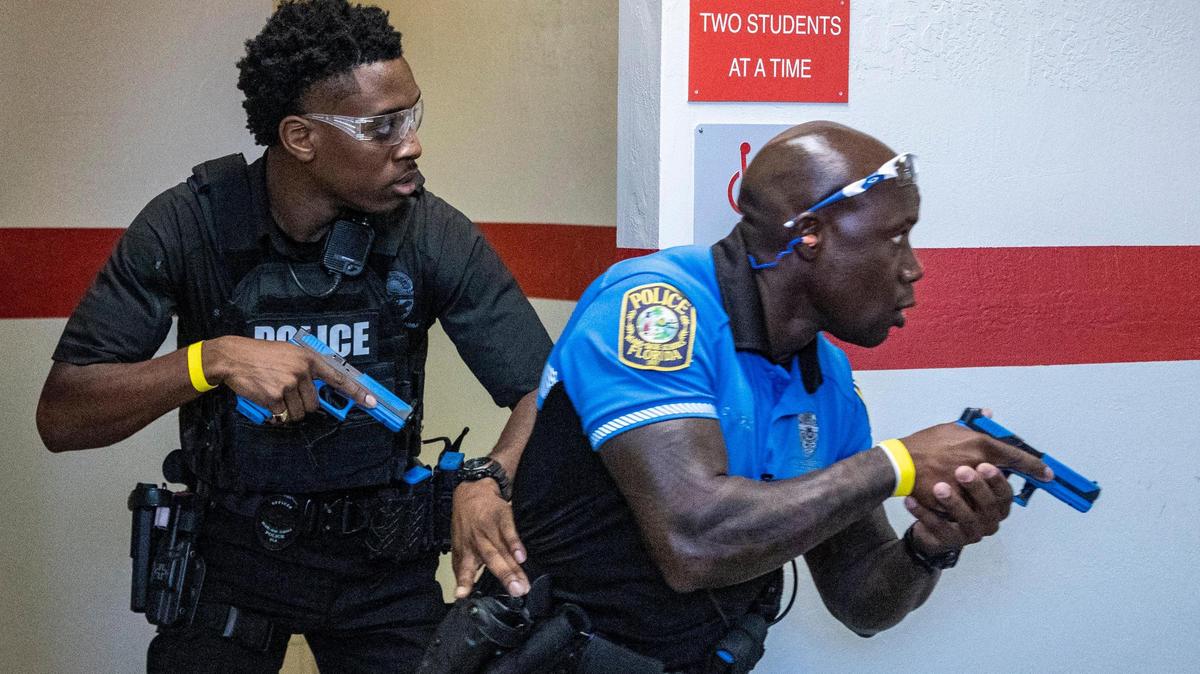 Miami-Dade Schools Police officers leave a bathroom after clearing it during an active shooter drill held at Coral Gables Senior High School on Friday, July 15, 2022.