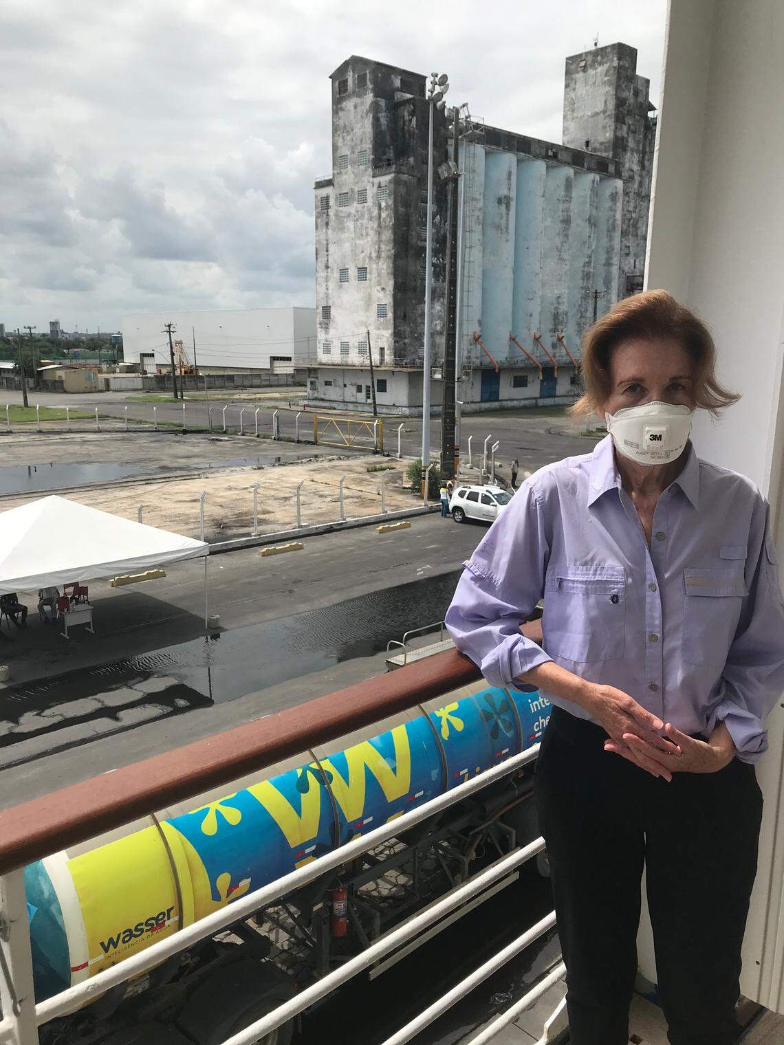 Susan Gary of Palm Beach, Florida stands on her cabin balcony of the Silver Shadow cruise ship, which is stuck in Recife, Brazil after a passenger tested positive for COVID-19 on March 14.
