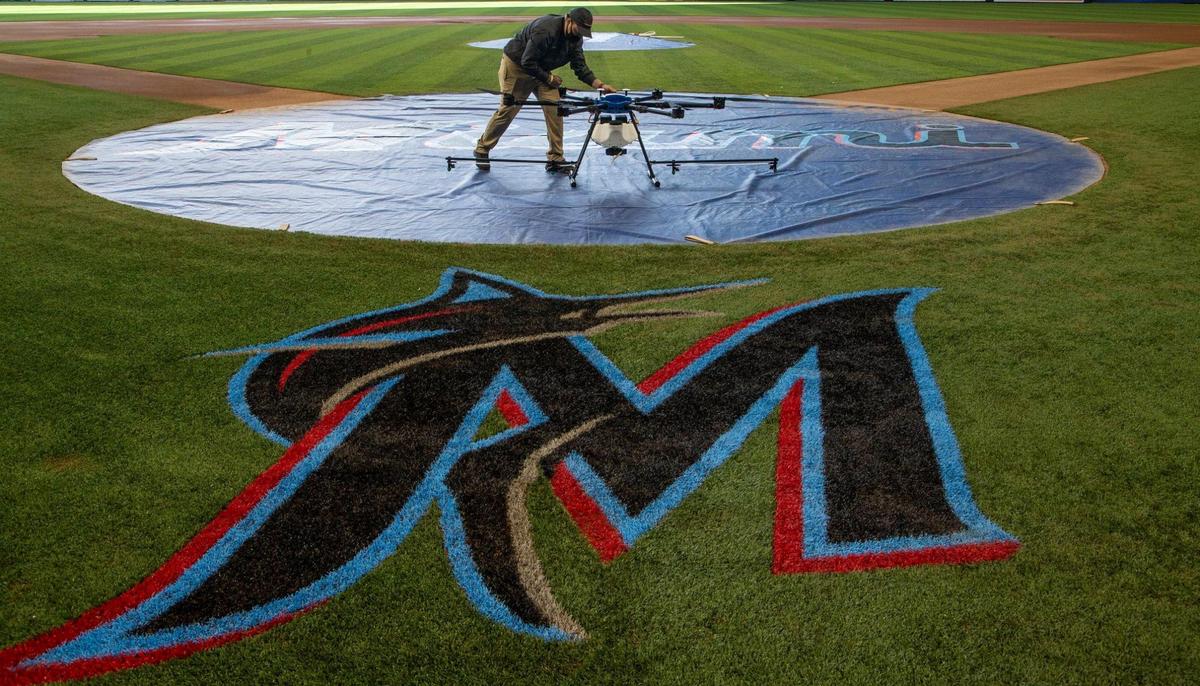 Drone pilot Brett Joseph inspect a drone used to spray disinfectant at Marlins Park for the 2021 regular baseball season and ballpark events on Thursday, March 18, 2021.