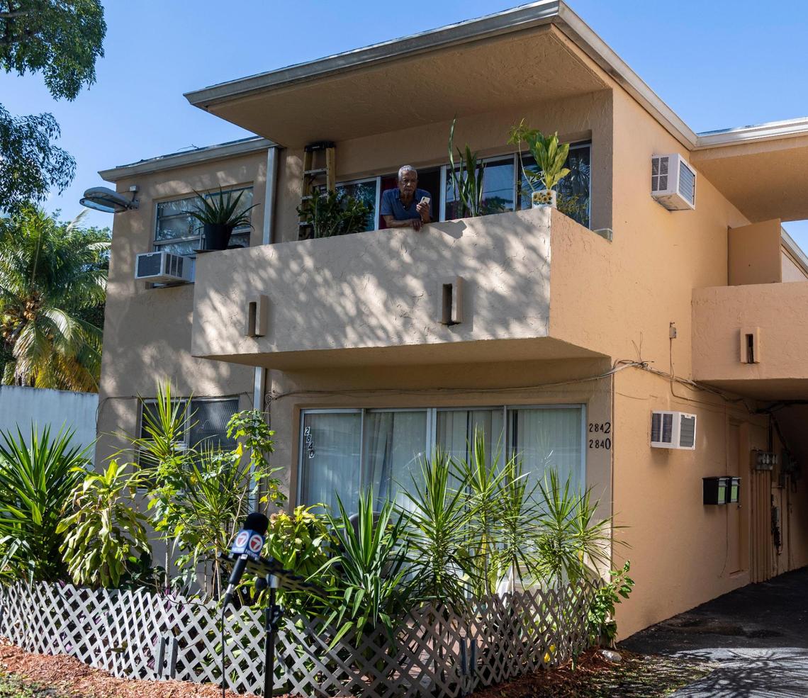 Miami, FL- November 28, 2022 - With A/C units already installed in his apartment, Julio Banegas a resident of 2842 NW 10th Avenue in Miami, looks out from his balcony as Miami-Dade County officials prepare to hold a press conference to announce an initiative by Miami-Dade County to fund hundreds of new A/C units for public housing apartments.