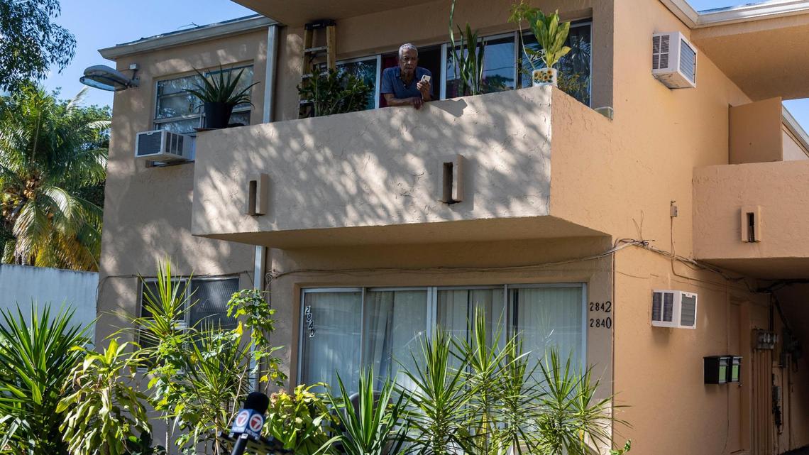 Julio Banegas of Miami, with air-conditioning installed in his apartment, looks out from his balcony in Nov. 28 as Miami-Dade County officials announce plans to fund hundreds of new A/C units in public housing.