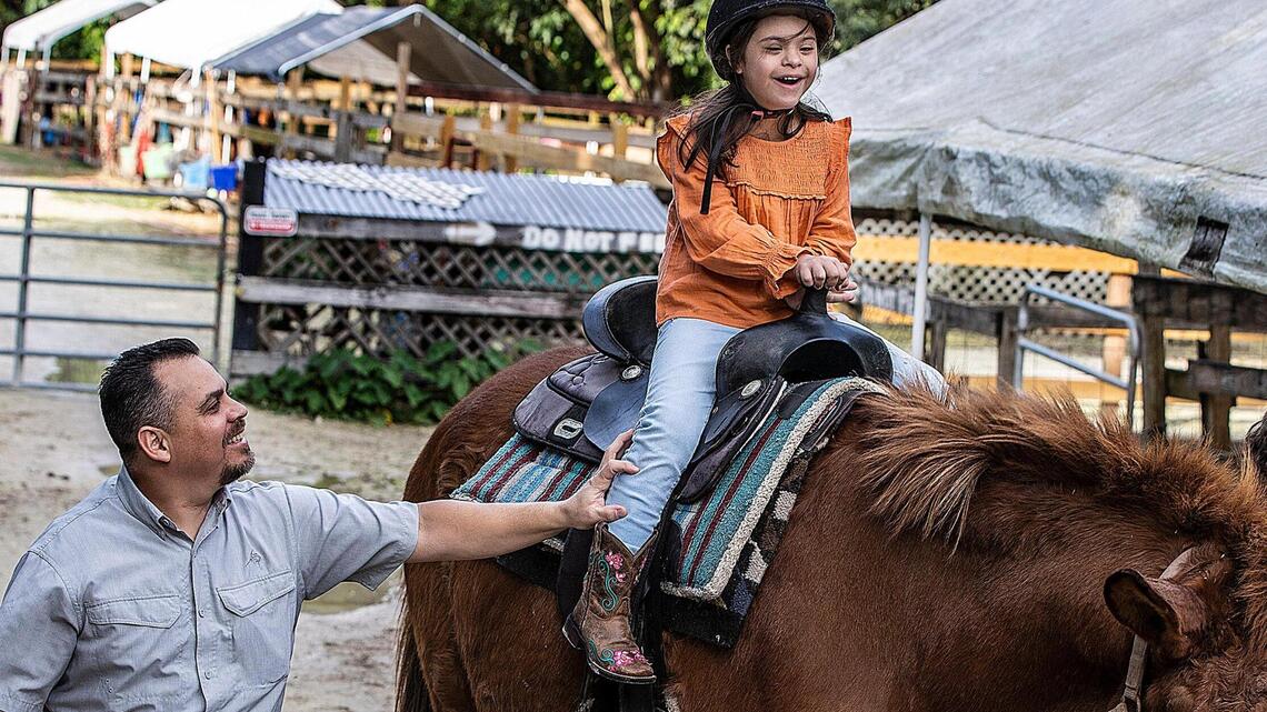 Down syndrome limits her communication skills, but it’s clear animals make her happy