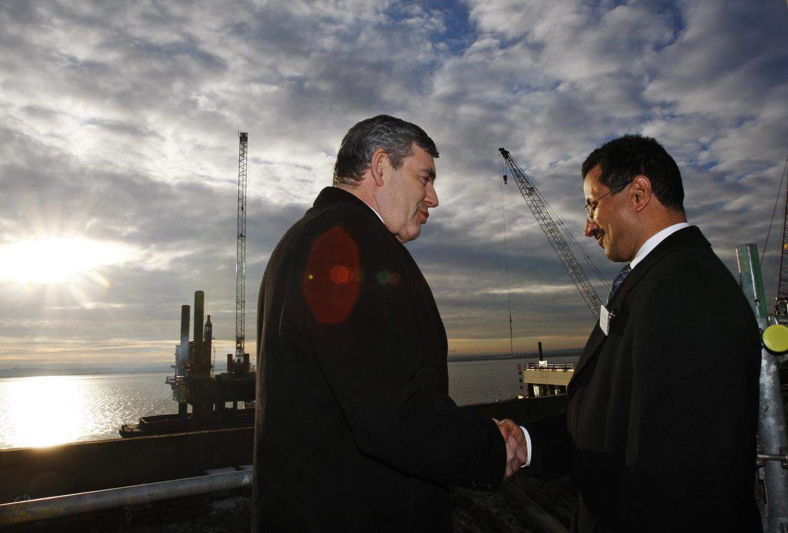 THURROCK, UNITED KINGDOM: Britain’s Prime Minister Gordon Brown (L) shakes hands with DP World chairman Sultan Ahmed Bin Sulayem during a visit to the port construction site on January 5, 2010 near Thurrock in southeast England. The Prime Minister’s visit marks the start of one of Britain’s largest infrastructure projects to create Europe’s largest combined deep-sea port and logistics park. (Photo by Luke MacGregor/WPA Pool/Getty Images)