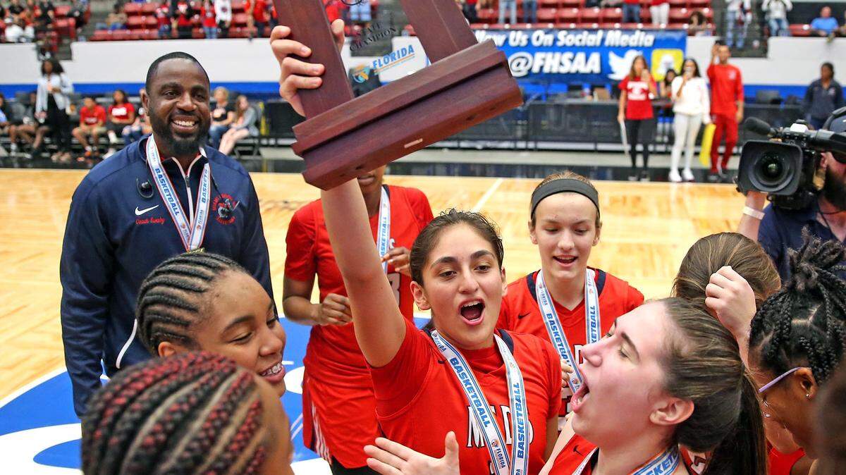 Miami Country Day Maria Alvarez (1) holds the trophy after they defeated Carrollwood Day in the 4A Finals Girl’s State Basketball Championships at the RP Funding Center in Lakeland, Florida, Thursday, February, 28, 2019.