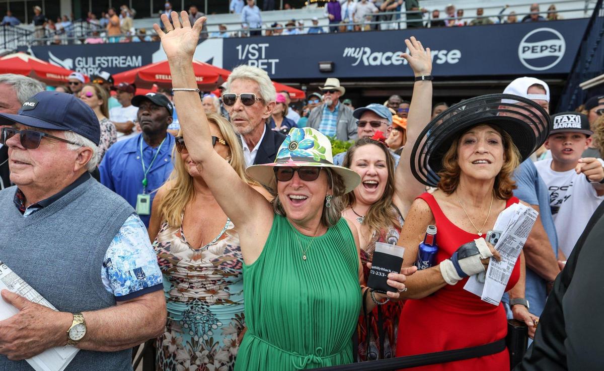 Susie Slater and Dayna Kimmins react during a horse race at Gulfstream Park in Hallandale Beach, Florida, on Friday, March 28, 2025.