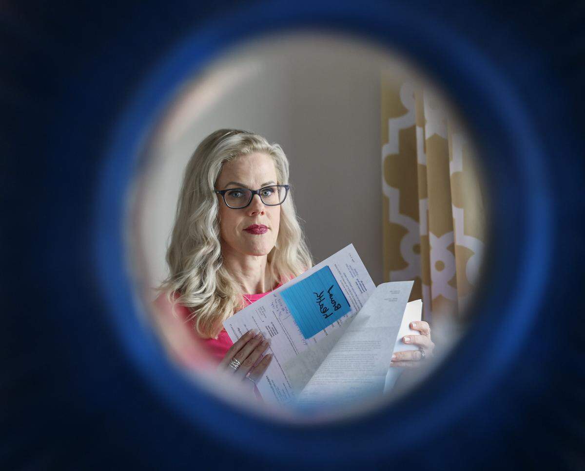 Kendra Fletcher, a Pompano Beach resident, is disputing an $11,517.71 bill from her daughter's emergency room visit at Broward Health, citing ongoing contract disputes between Broward Health and Florida Blue.  Kendra is seen through a mirror as she contends the visit should be covered under the federal No Surprises Act, which protects patients from surprise medical bills for emergency care on Monday, May 4th, 2026, in Pompano Beach, Florida.