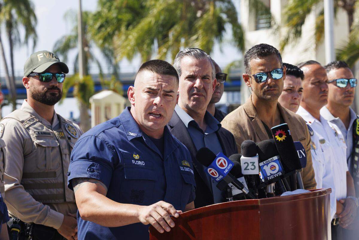 Capt. Frank Florio III, commanding officer Coast Guard Sector Miami, center, speaks during a Coast Guard press conference on Tuesday, July 29, 2025, at the Coast Guard Sector Miami in Miami Beach providing an update on the boat crash off Hibiscus Island in Miami Beach on Monday. A barge pushed by a tugboat crashed into a Miami Yacht Club sailboat, killing two young girls and seriously injuring two others. 