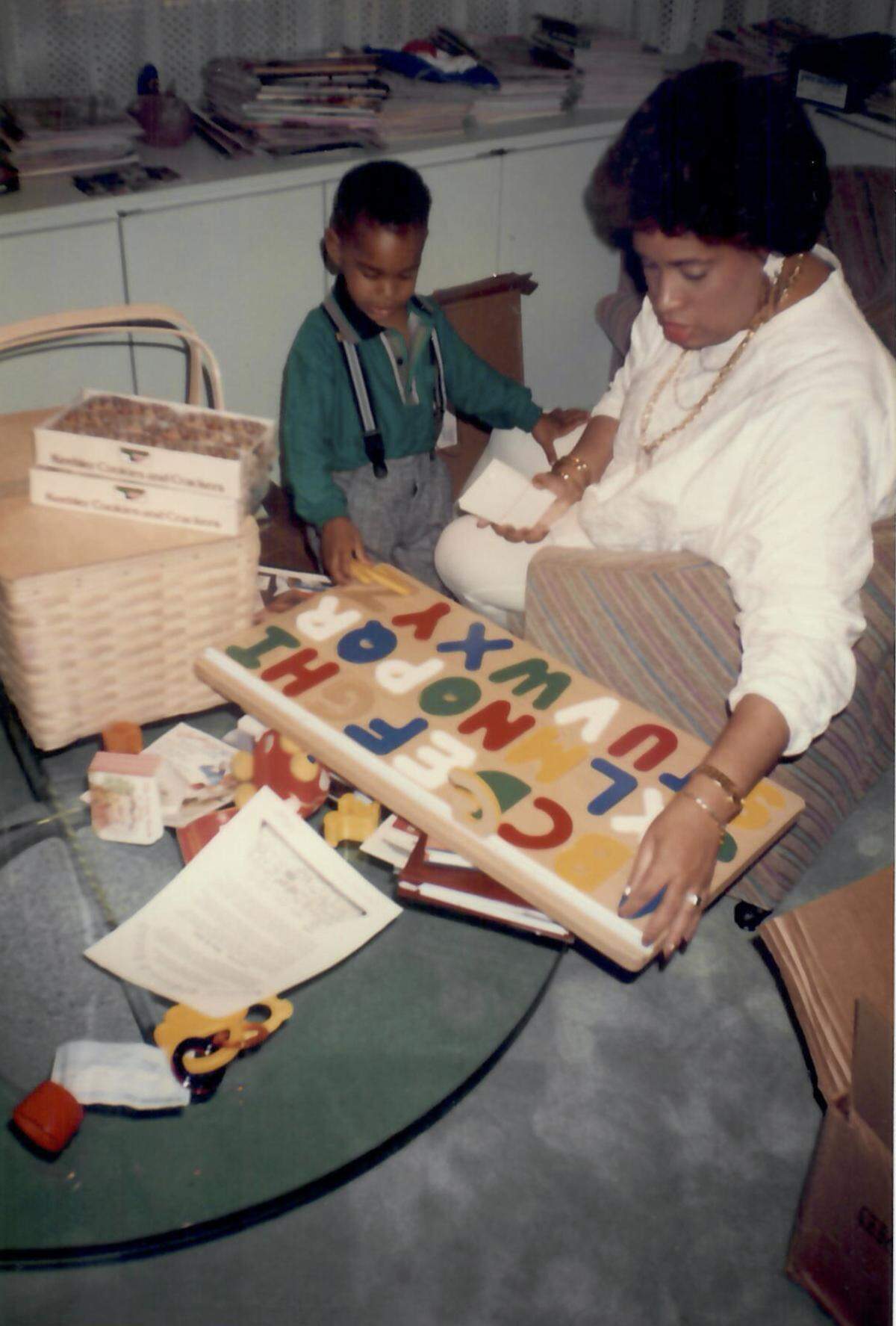A young Garth Reeves III plays with his mother Rachel at The Miami Times office. Reeves would succeed his mother as publisher in 2017.