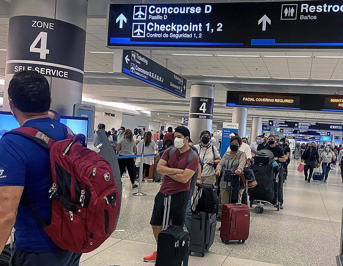 Long lines were seen at American Airlines Concourse D at Miami International Airport this morning, Friday, May 21, 2021, as a nationwide technical issue with Sabre, a booking system American Airlines and other carriers use, caused flight delays across the country.