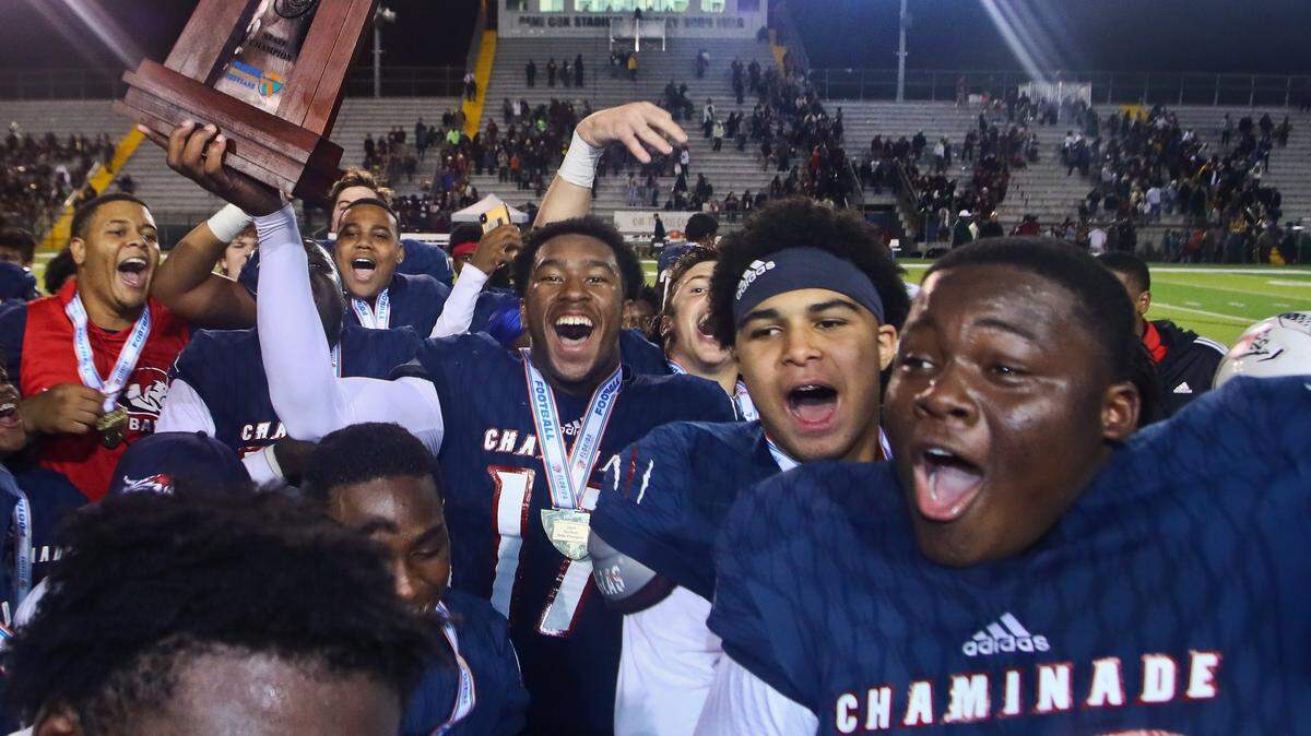 Chaminade-Madonna tight end Claude Larkins, holding the trophy, defensive end Kijuan Reid-Jacques and defensive tackle Allan Haye, Jr. celebrate after their FHSAA Class 3A Football State Championship against Florida High Friday, Dec. 6, 2019 in Tallahassee, Fla. Chaminade-Madonna won 35-20.