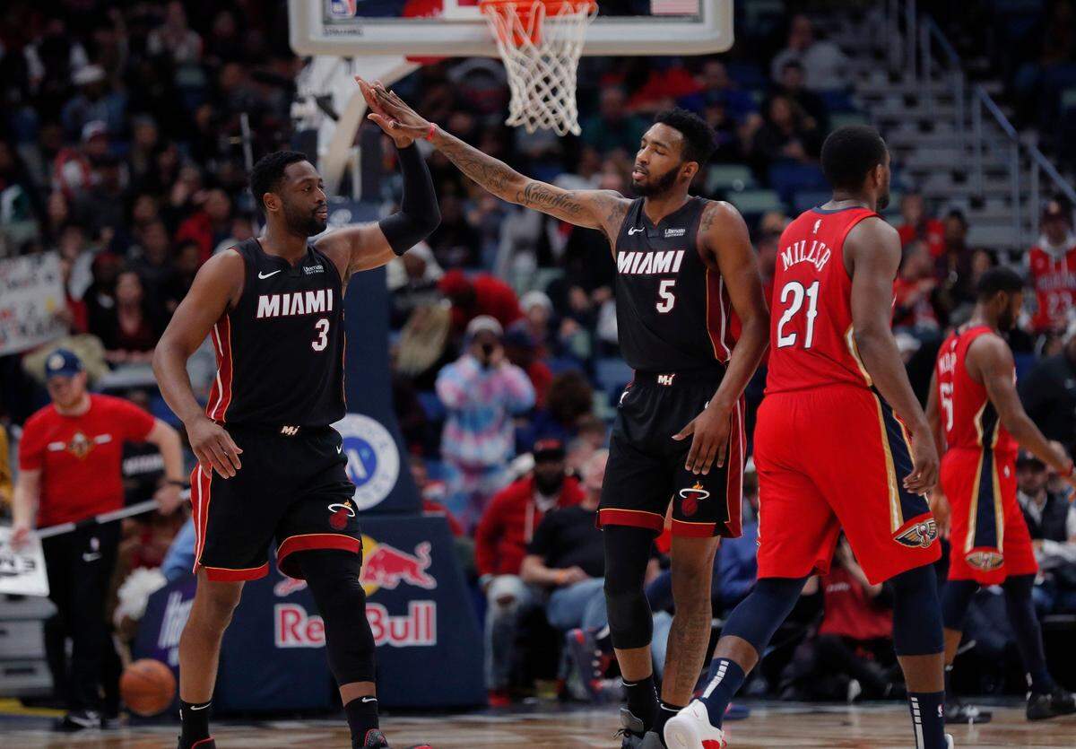 Miami Heat guard Dwyane Wade (3) and Miami Heat forward Derrick Jones Jr. (5) celebrate in the second half of an NBA basketball game against the New Orleans Pelicans in New Orleans, Sunday, Dec. 16, 2018.