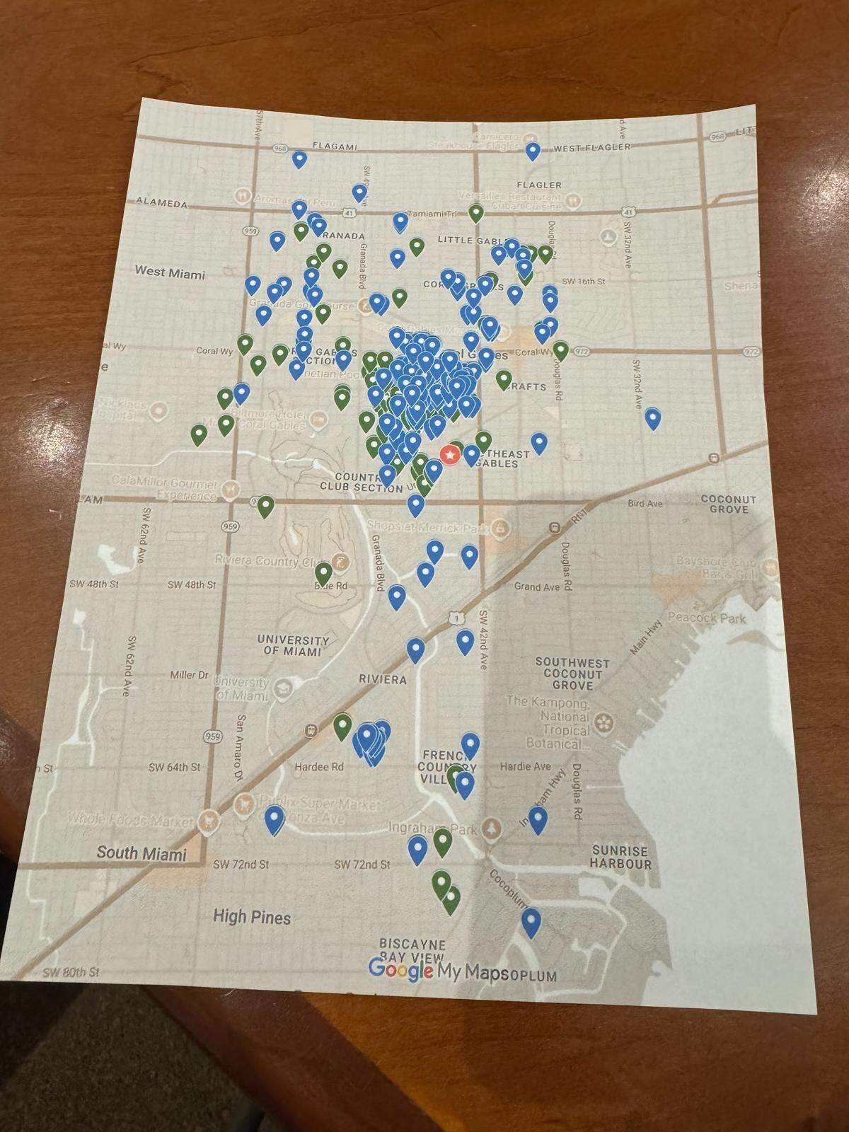 A map Coral Gables resident Mary Powell presented to commissioners on Tuesday, Jan. 13, 2026, showing the number of residents in the city supporting the creation of a new dog park. Blue markers represent residents who support the University Drive dog park. The green markers represent signatures Powell previously acquired to create a dog park in nearby Catalonia Park. Powell said all residents marked on the map overall support dog parks in the city.