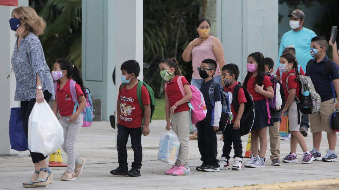 First-graders at Redland Elementary in Homestead are led into the classroom by their teacher after being dropped off by their parents on Oct. 5, 2020, the first day of school reopenings for in-person classes at Miami-Dade County Public Schools. Miami-Dade Public Schools Superintendent Alberto Carvalho announced Tuesday, Nov. 9, 2021, that parents of all Miami-Dade public school students can opt out their children from wearing masks due to declining COVID cases in the county.